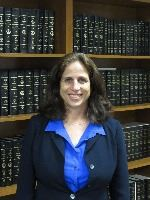 susan woman standing in front of bookshelf